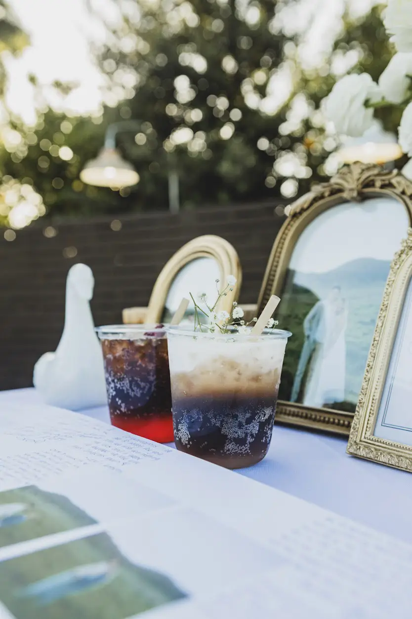 Layered craft sodas with house-made syrups and baby's breath garnish styled on a wedding reception table at The Grove Redlands